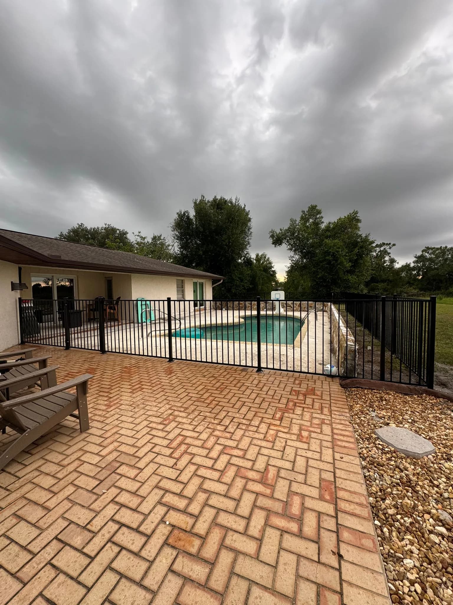Aluminum pool fence installed around a residential pool area