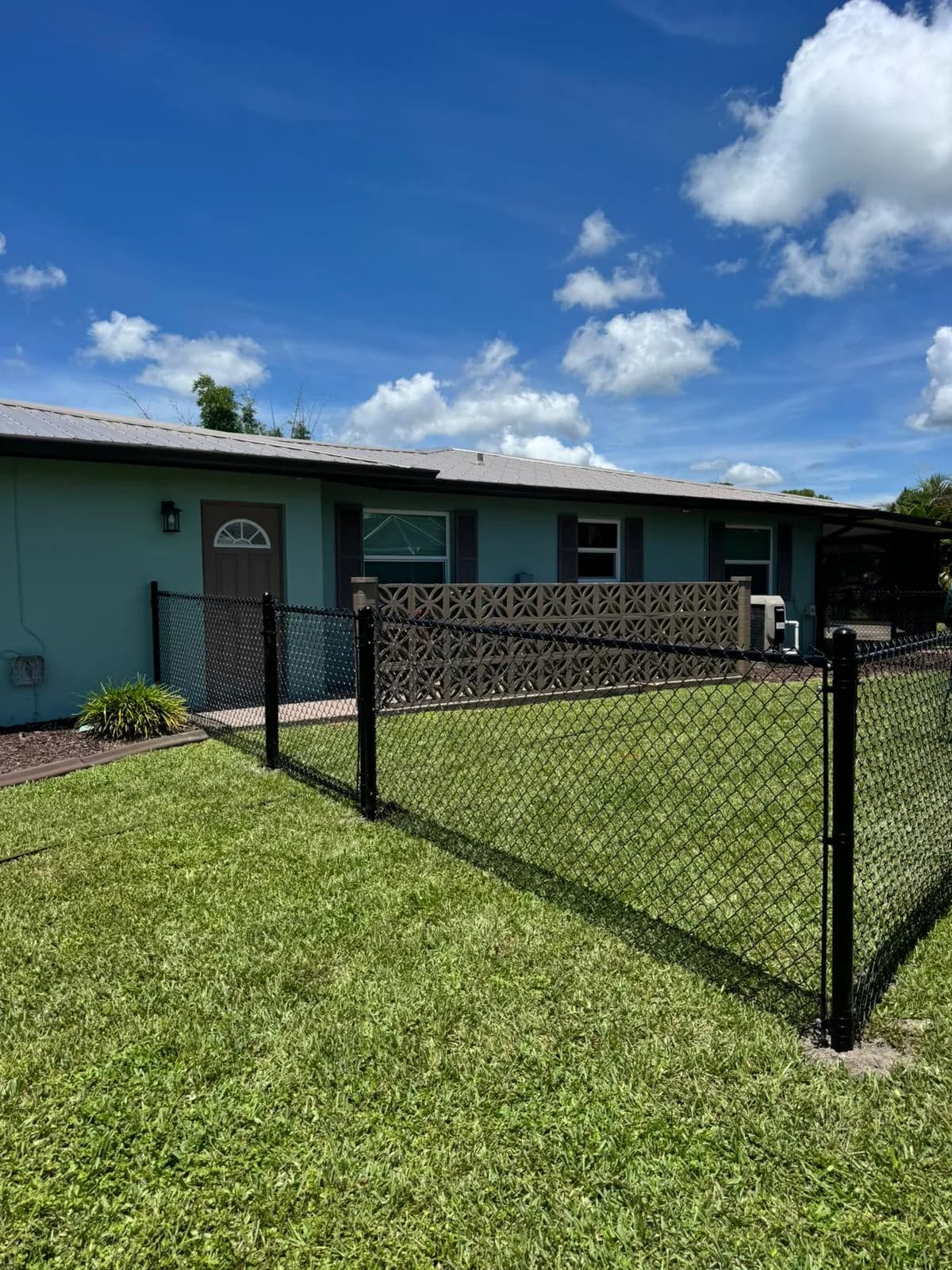 Vinyl-coated chain link fence installed by True Fence Florida