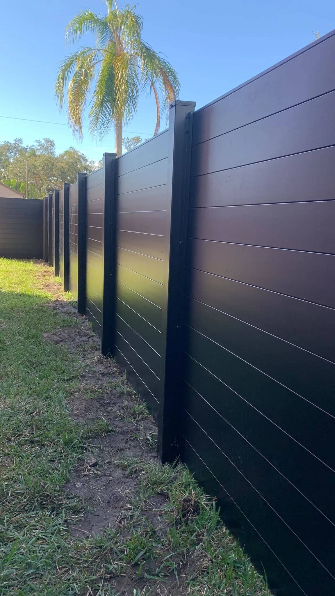 Black aluminum privacy fence installation