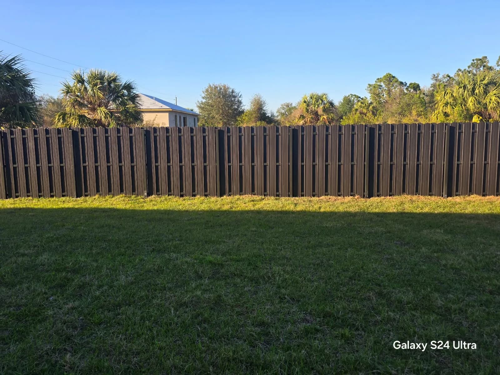 Finished metal privacy fence beside a Florida home