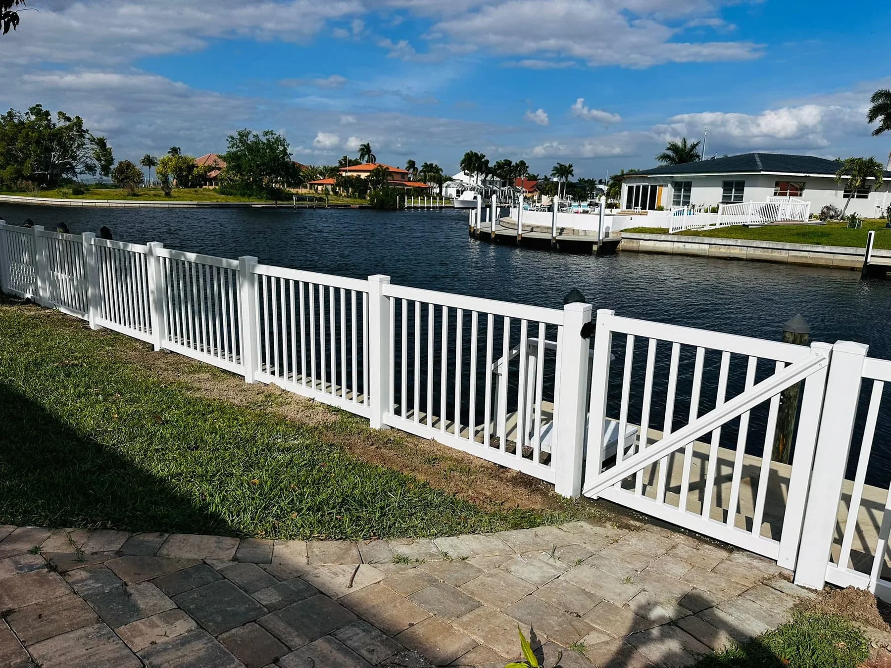 White vinyl fence with a poolside residential layout