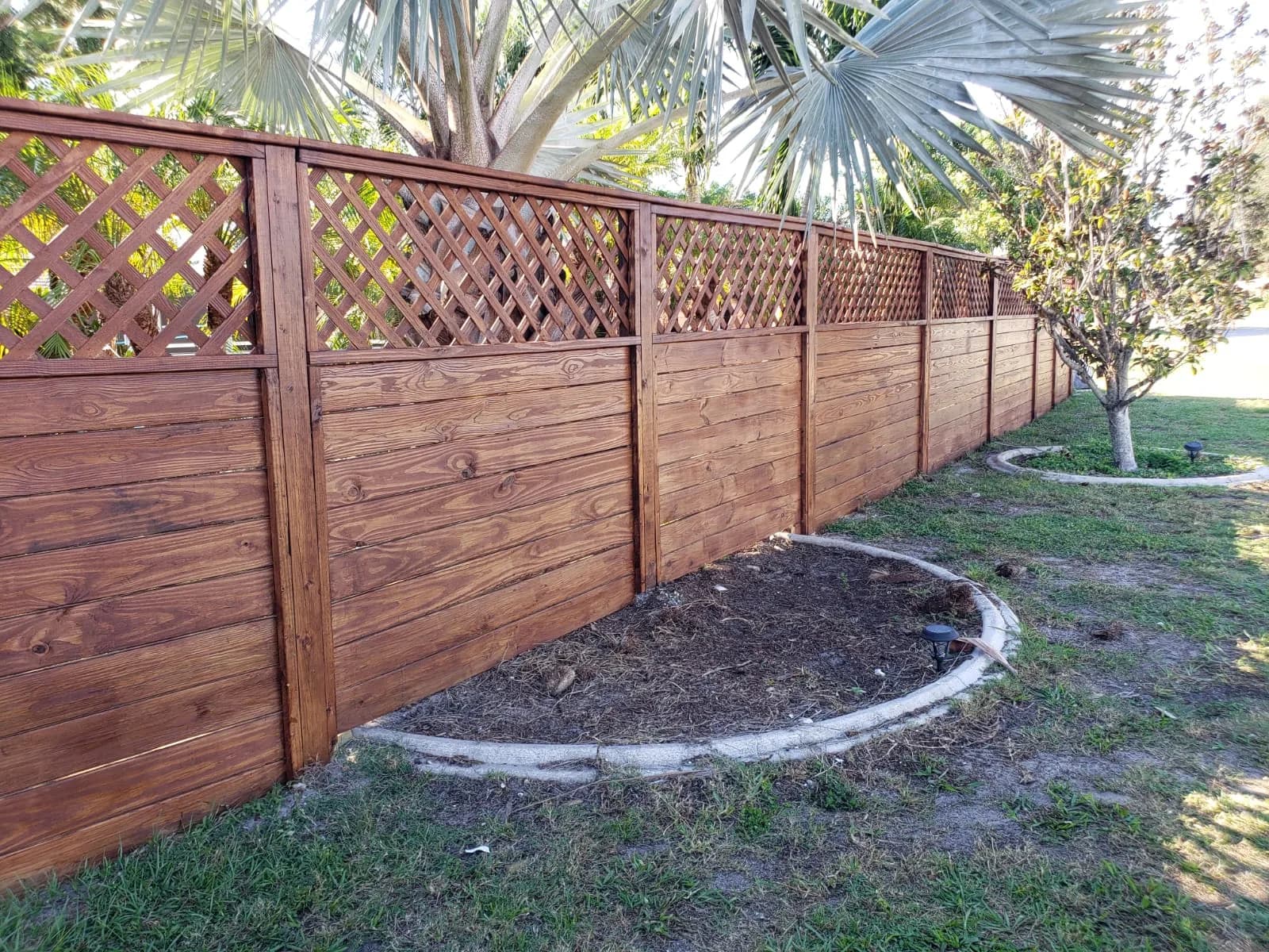 Horizontal wood privacy fence installed in a residential yard